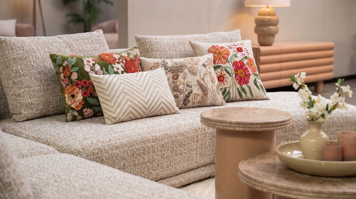 Cushions in sand and rust tones on a sofa
